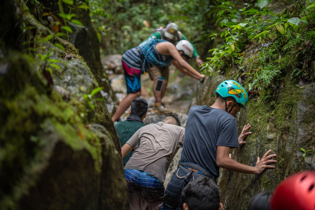Group of hikers traversing rugged rocks in Peru, showcasing adventure and teamwork.